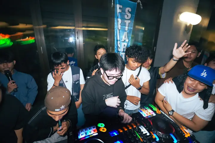 DJ surrounded by a crowd at Fresh Start